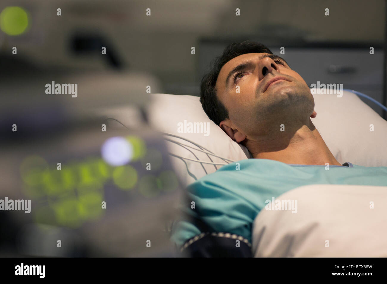 Male patient lying in hospital bed Stock Photo