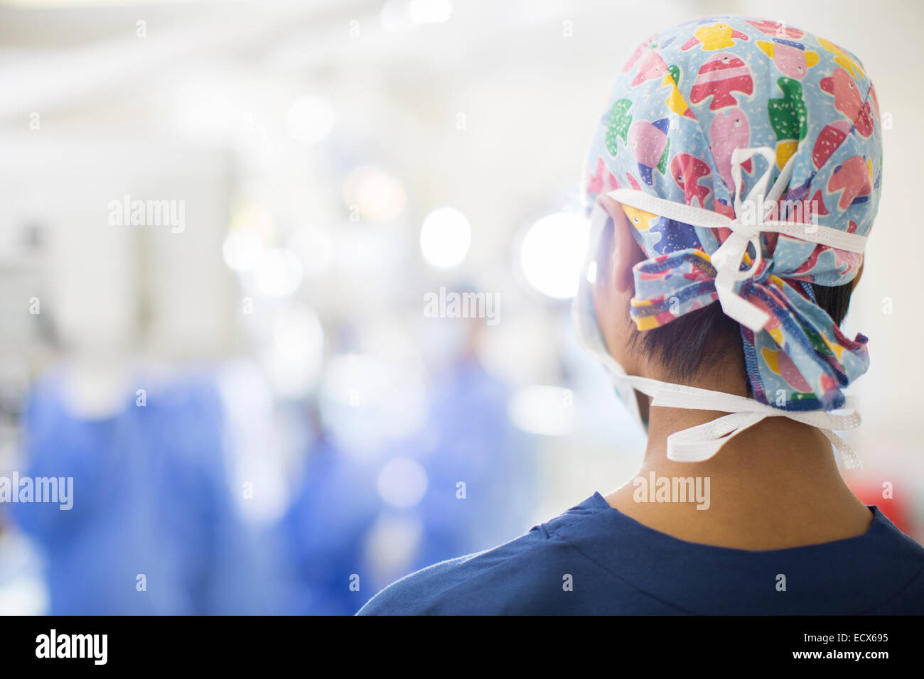 Rear view of young nurse standing in operating theater Stock Photo