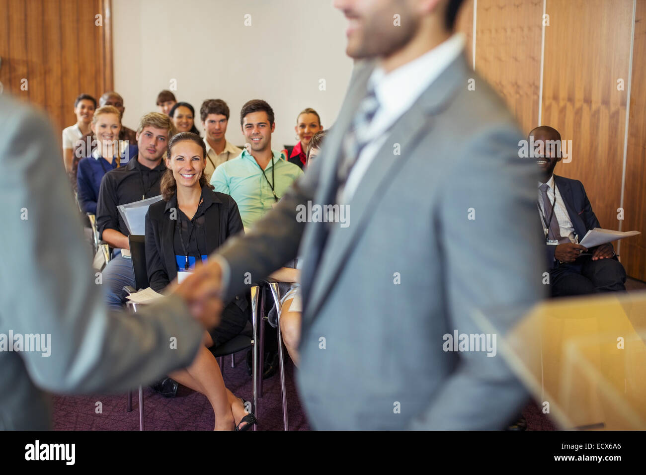 Two businessmen shaking hands during conference in conference room Stock Photo