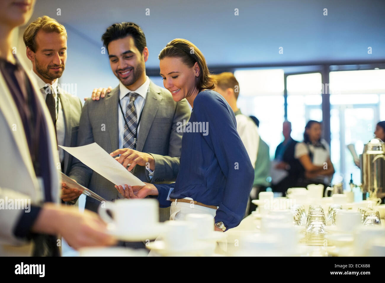 Portrait of businesspeople in lobby of conference center during coffee break Stock Photo
