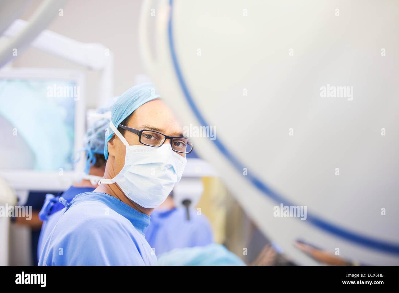 Portrait of masked surgeon in operating theater Stock Photo