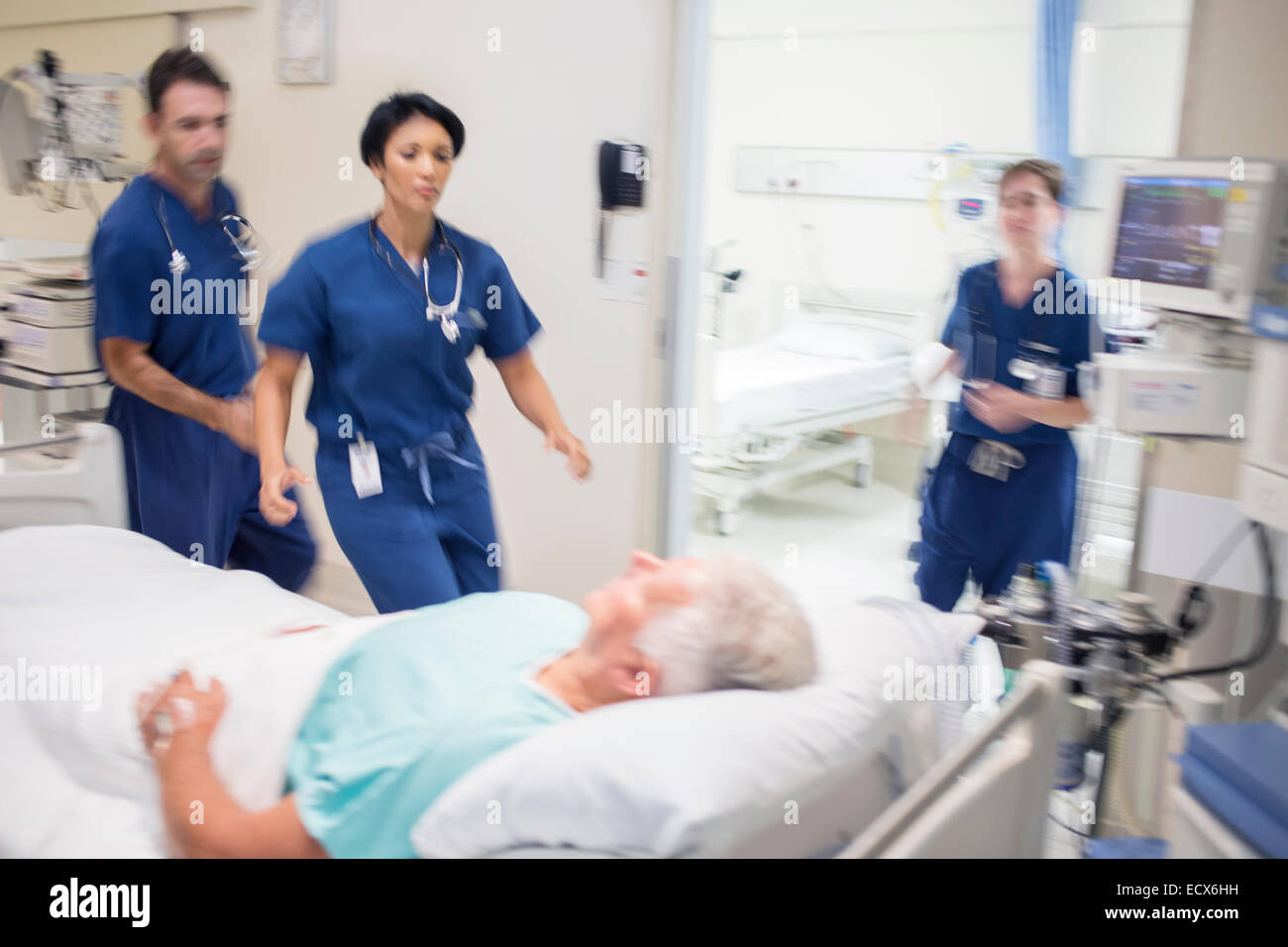 Doctors rushing to rescue patient in hospital Stock Photo