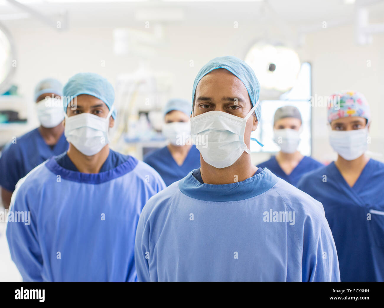 Group portrait of team of masked surgeons in hospital Stock Photo