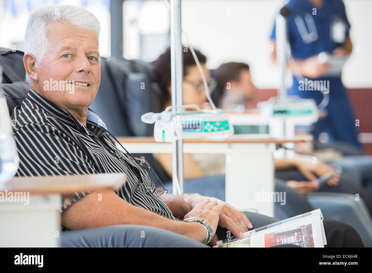 Smiling man undergoing medical treatment in outpatient clinic Stock Photo