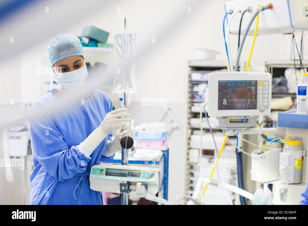 Nurse standing by medical and monitoring equipment Stock Photo