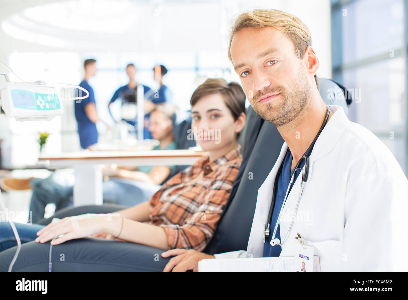 Portrait of doctor and patient undergoing medical treatment in outpatient clinic Stock Photo