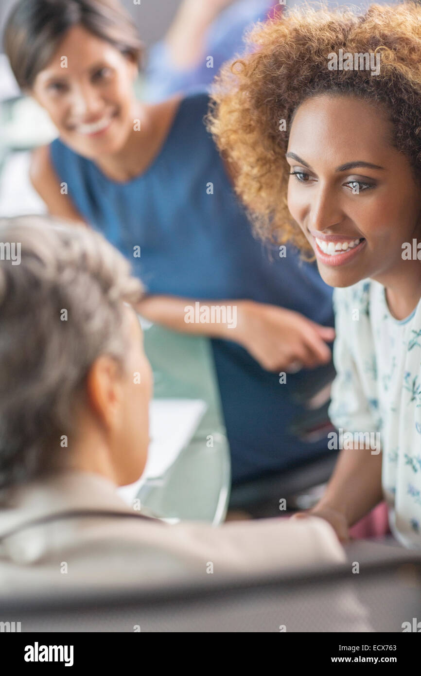 Smiling businesswomen talking in conference room Stock Photo