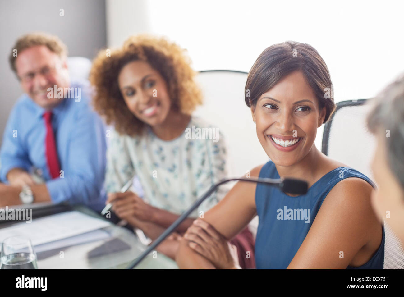 Portrait of smiling woman sitting at conference table Stock Photo
