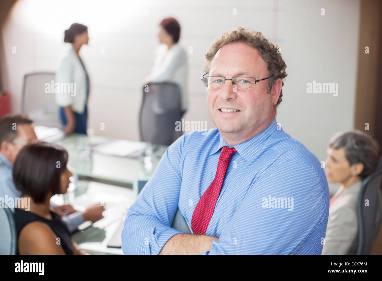 Portrait of mature man wearing glasses in conference room Stock Photo
