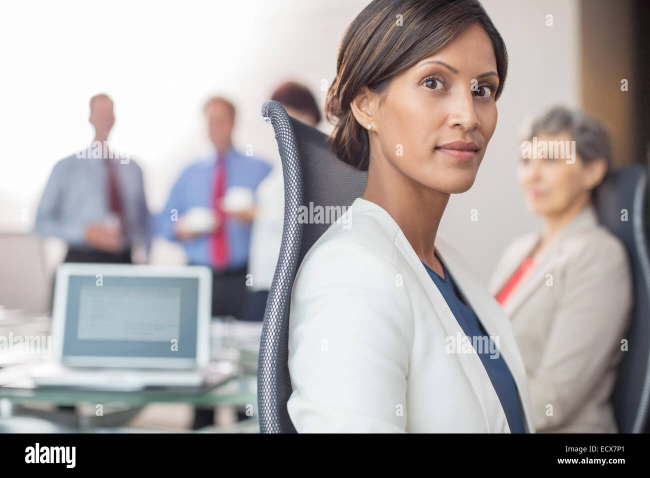 Portrait of beautiful businesswoman sitting in office Stock Photo - Alamy