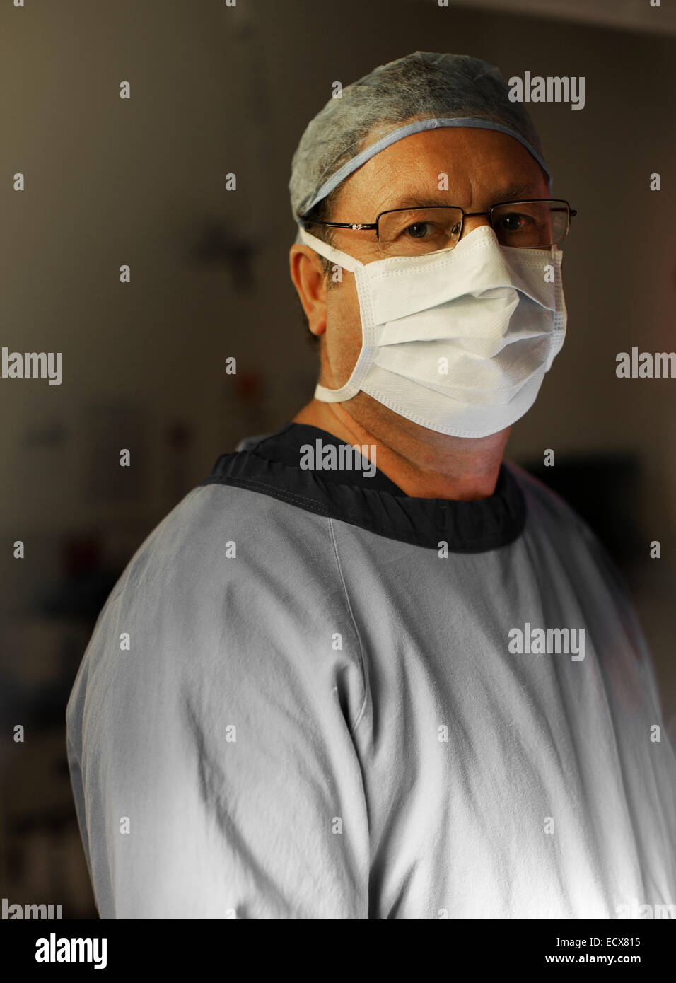 Portrait of mature surgeon by operating theater Stock Photo