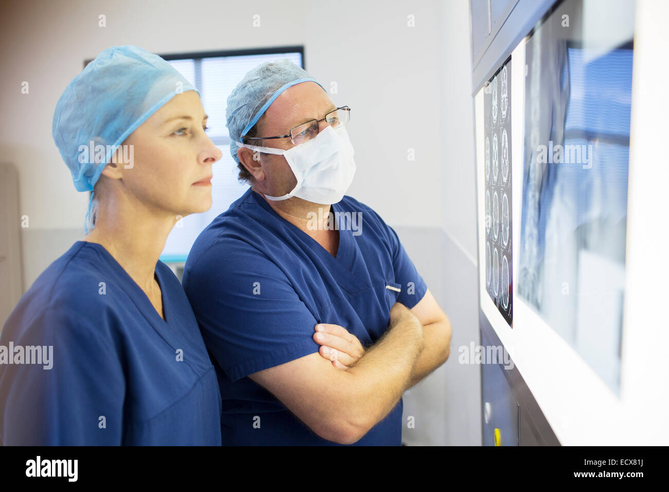 Two  doctors discussing patient's x-ray and MRI before surgery Stock Photo