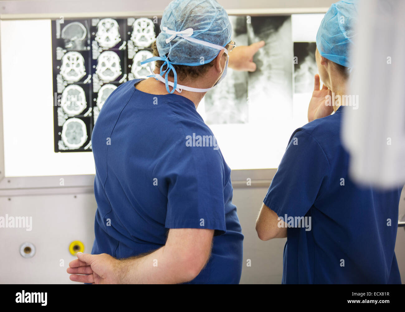 Two doctors discussing patient's x-ray and MRI scans Stock Photo