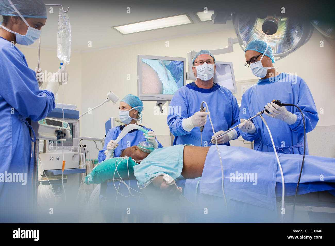 Team of surgeons operating on patient in hospital Stock Photo