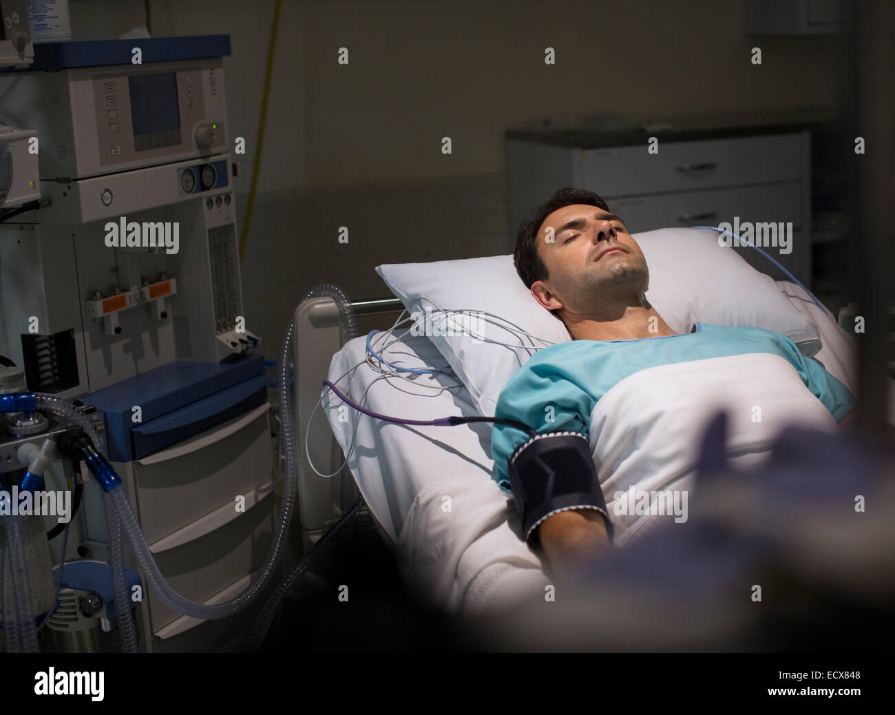 Male patient lying in hospital bed in intensive care unit Stock Photo ...