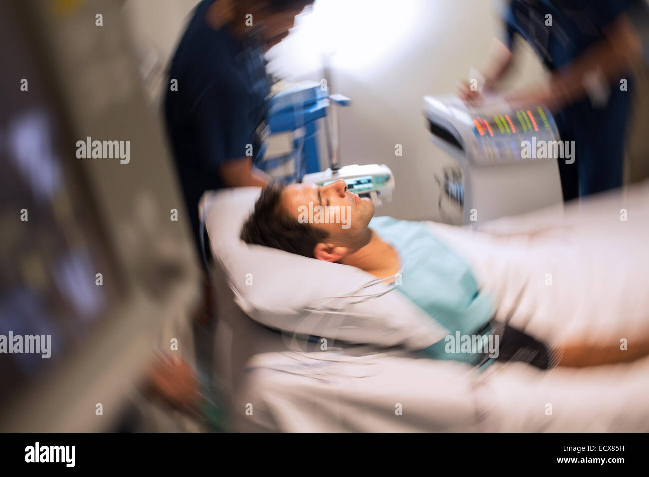 Blurred motion view of patient lying in bed in intensive care unit