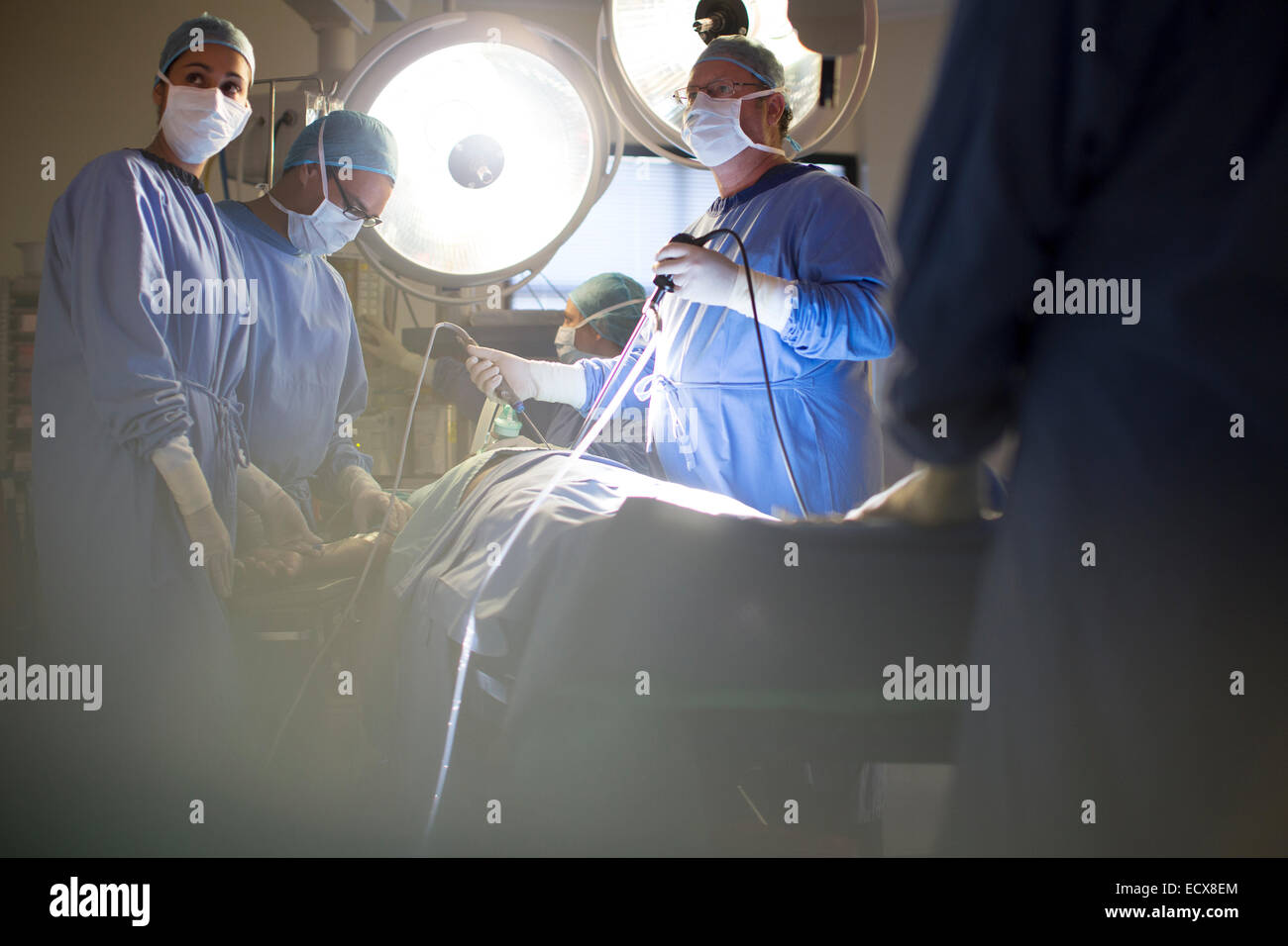 Team of doctors performing laparoscopic surgery in operating theater Stock Photo