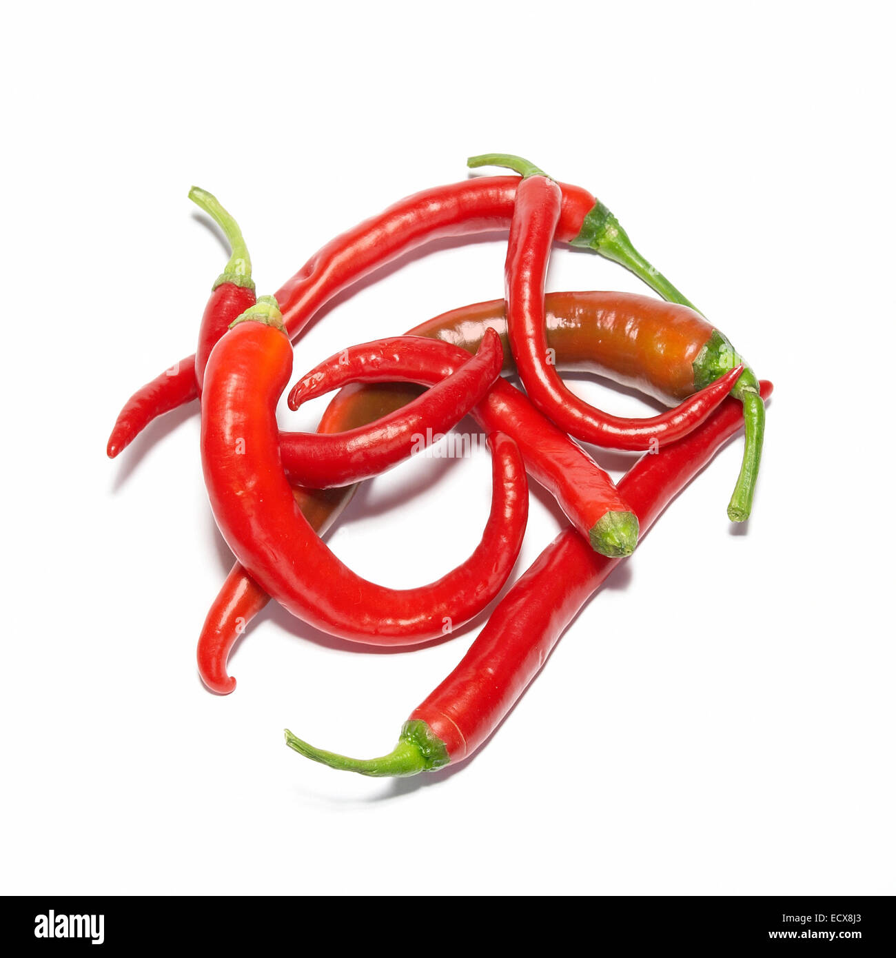 Stack of red hot chili peppers isolated on white Stock Photo - Alamy