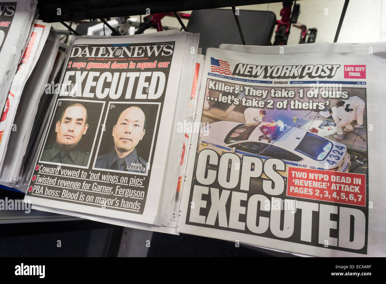 New York, USA. 21st Dec, 2014. The New York Daily News and the New York Post report on Sunday, December 21, 2014 about the assassination of two NYPD officers, Wenjian Liu and Rafael Ramos by Ismaaiyl Brinsley.  The officers were murdered in Brooklyn in their squad car by Brinsley allegedly in retaliation for the Eric Garner death. Brinsley killed himself in the subway during his attempted escape Credit:  Richard Levine/Alamy Live News Stock Photo