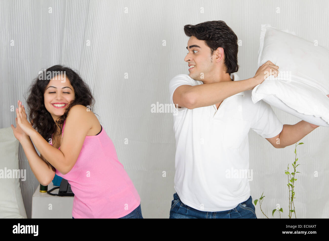 indian Beautiful Couple home Playing Mock Fight Stock Photo