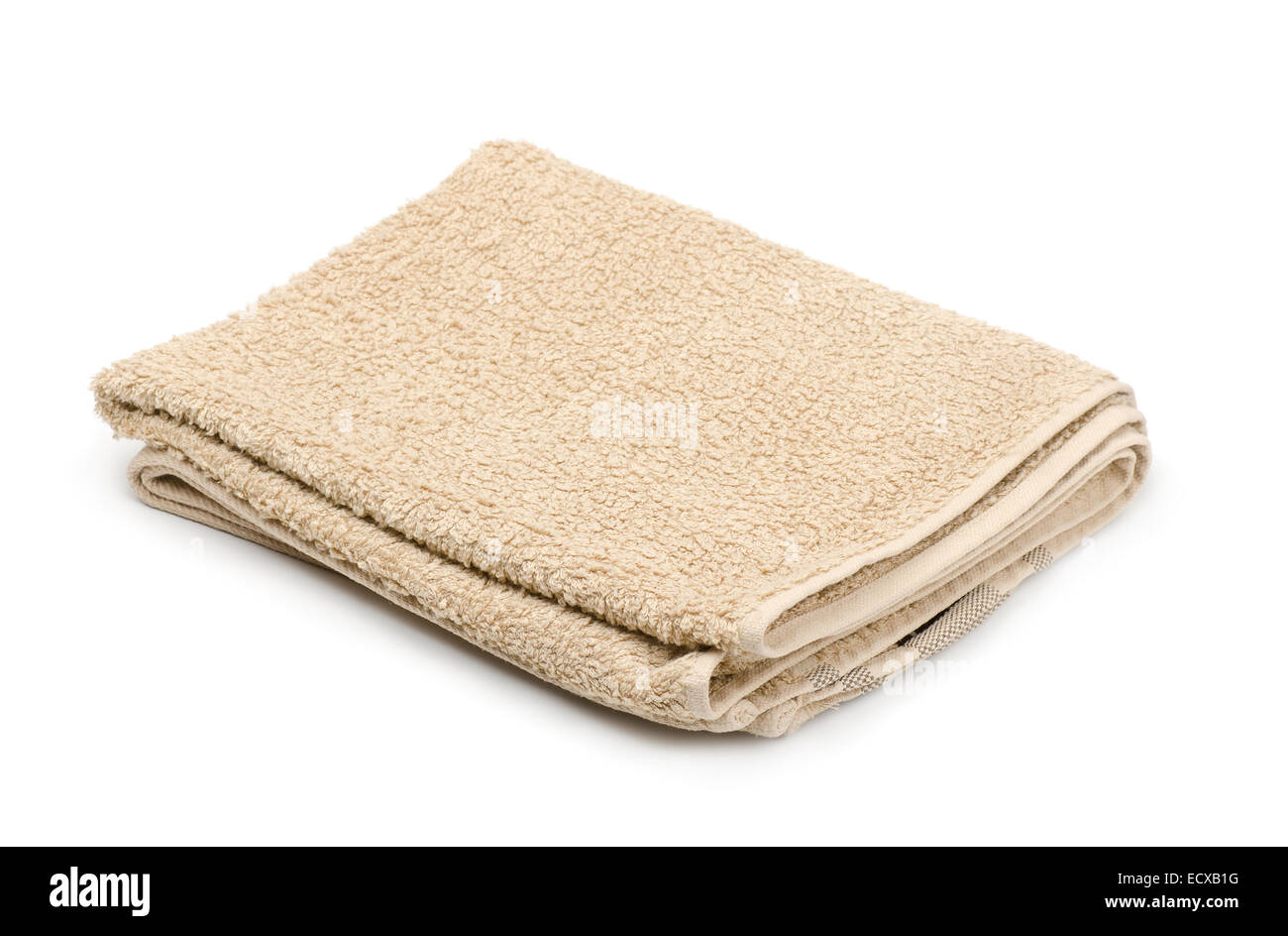 Folded beige terry towel isolated on white Stock Photo