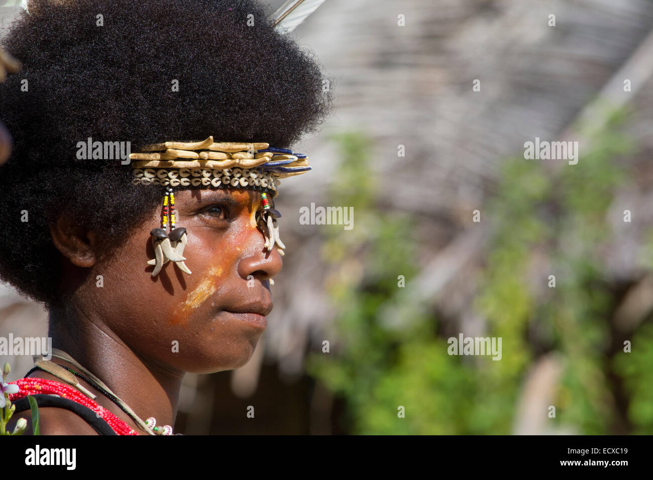 Melanesia, Papua New Guinea, Bismark Sea area, Tuam Island, Tuam village. Attractive young woman in beaded headband with shells Stock Photo
