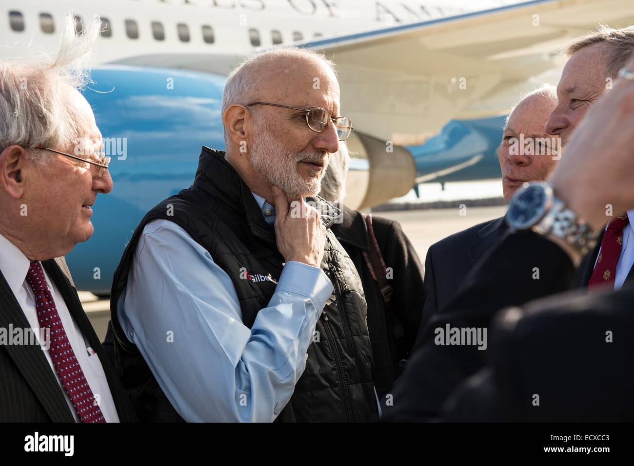 USAID contractor Alan Gross, imprisoned in Cuba for five years, is greeted by a group of Senators after a flight back from Cuba following his release December 17, 2014 at Andrews Air Force Base in Maryland. Stock Photo