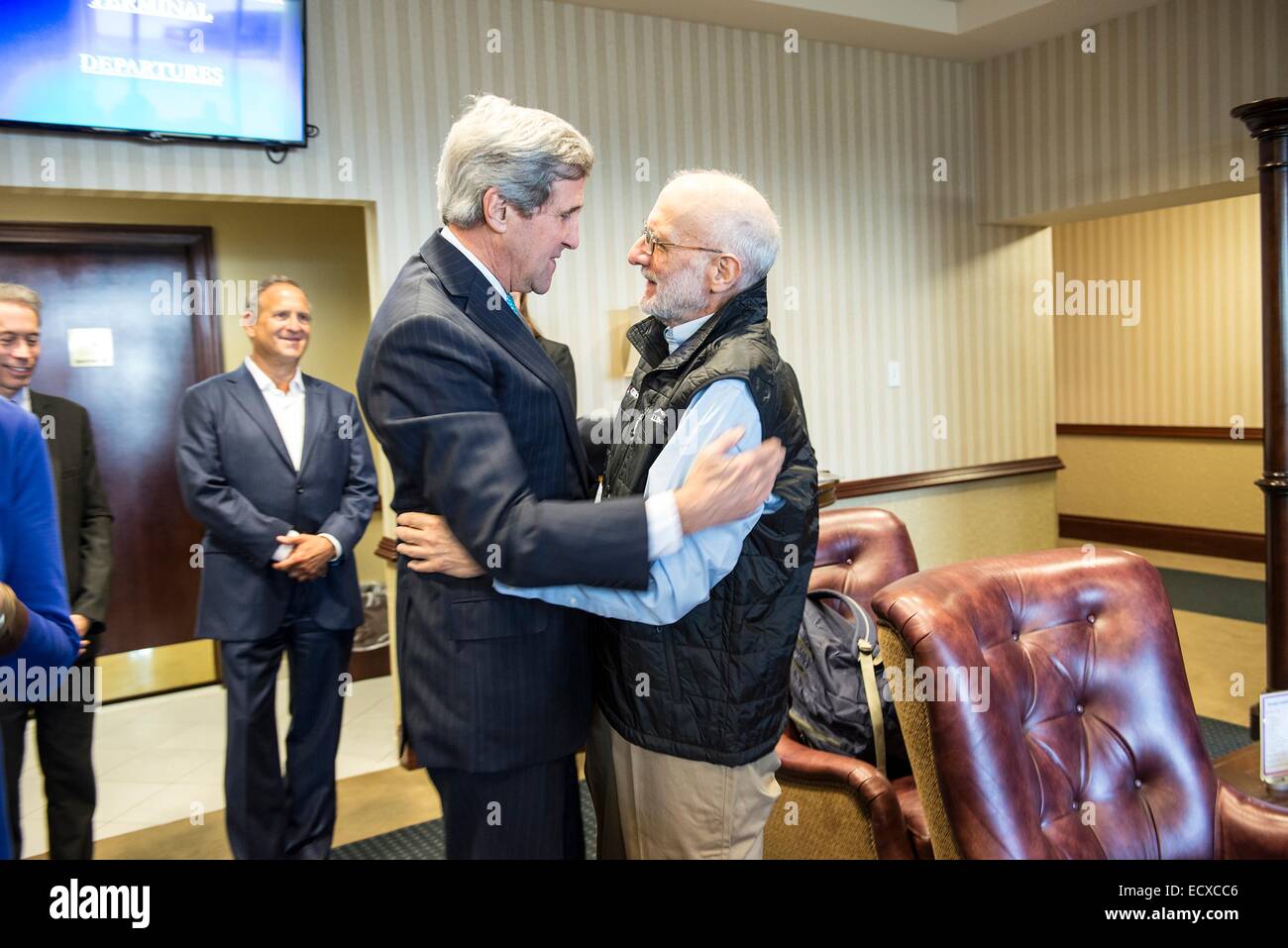 USAID contractor Alan Gross, imprisoned in Cuba for five years, is greeted by Secretary of State John Kerry after a flight back from Cuba following his release December 17, 2014 at Andrews Air Force Base in Maryland. Stock Photo