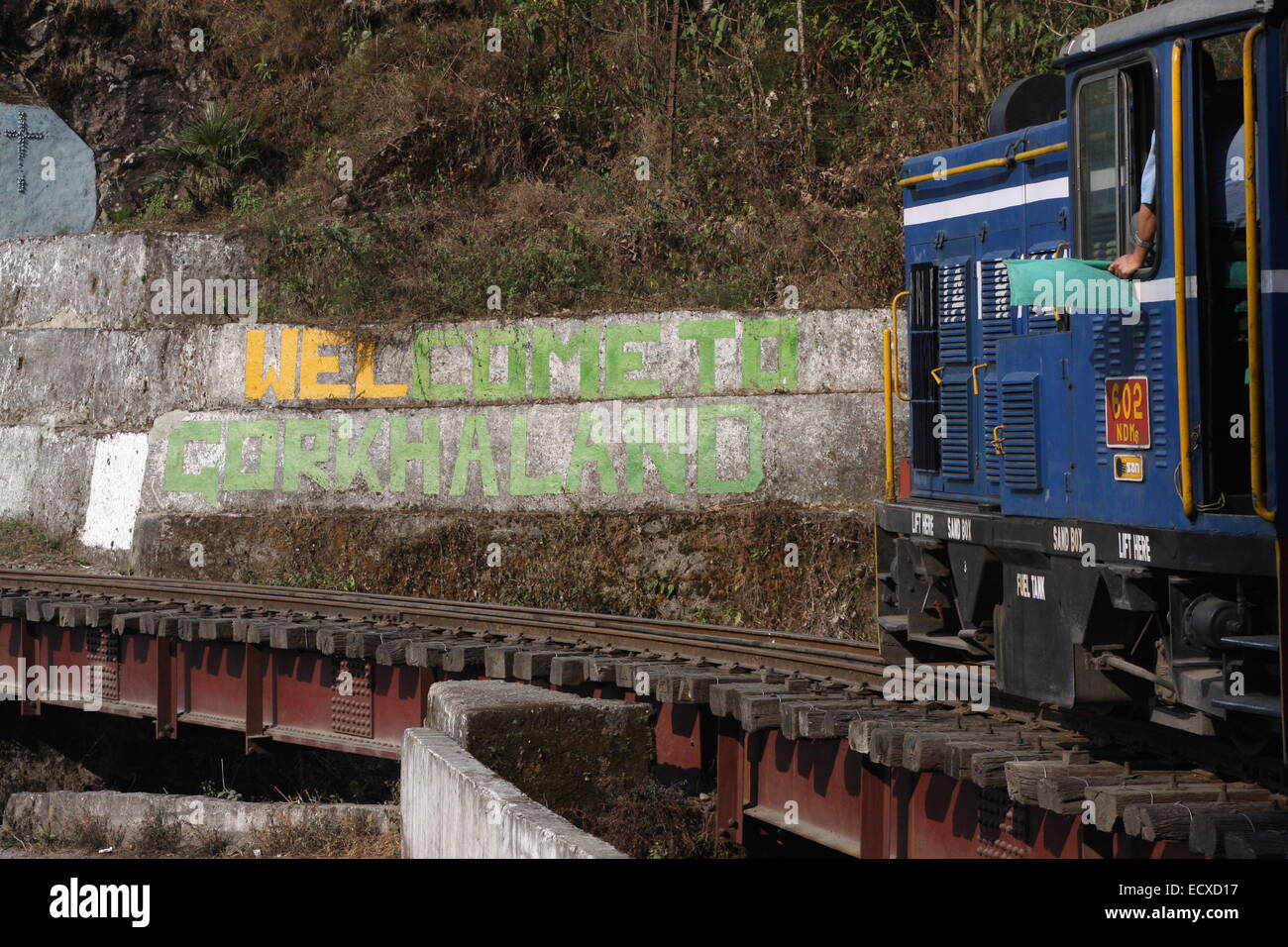 Darjeeling Himalayan Railway steam train travelling from Kurseong to Darjeeling, passing Gorkhaland propaganda en route Stock Photo