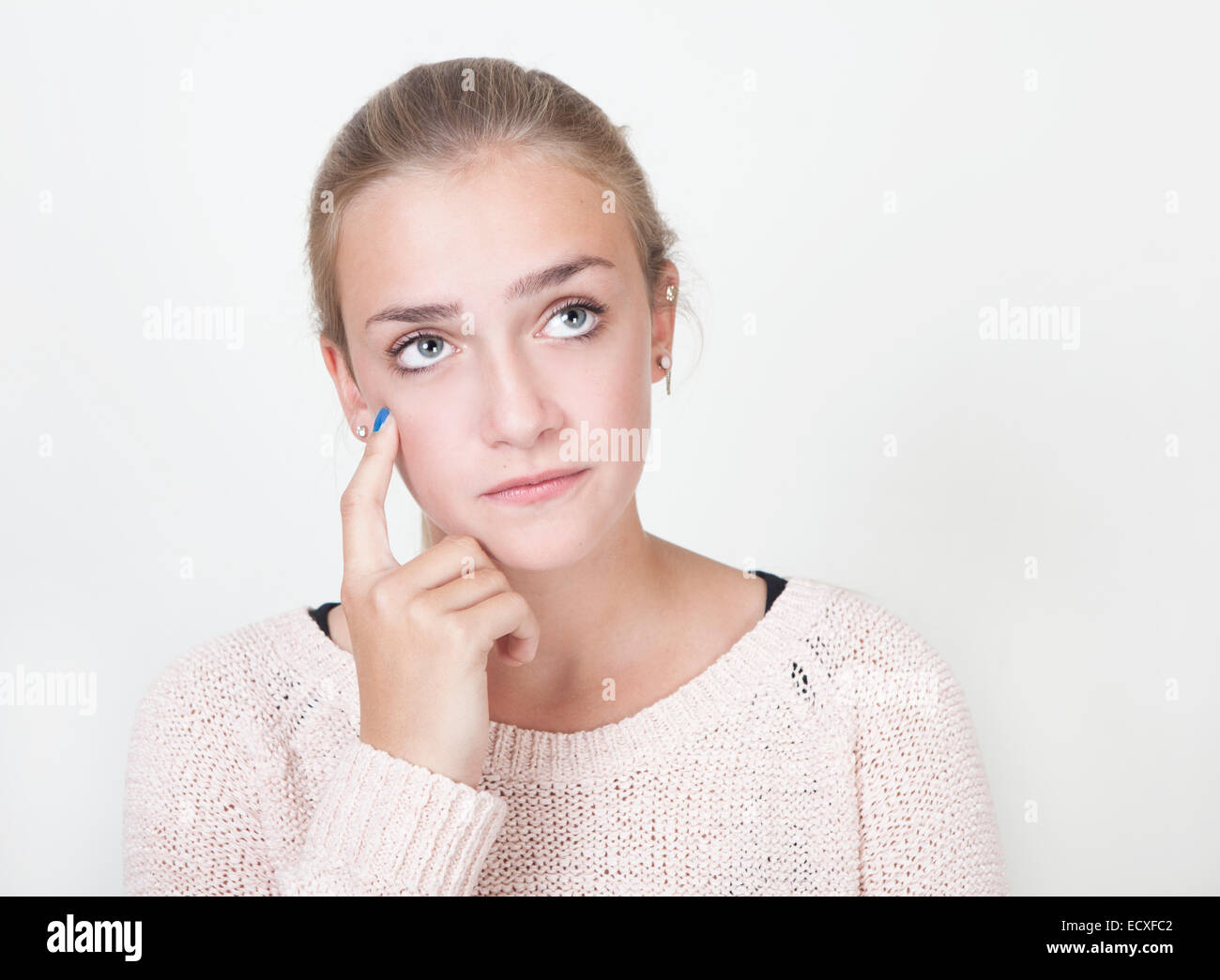 young woman with blond hair and blue eyes thinking, portrait Stock Photo