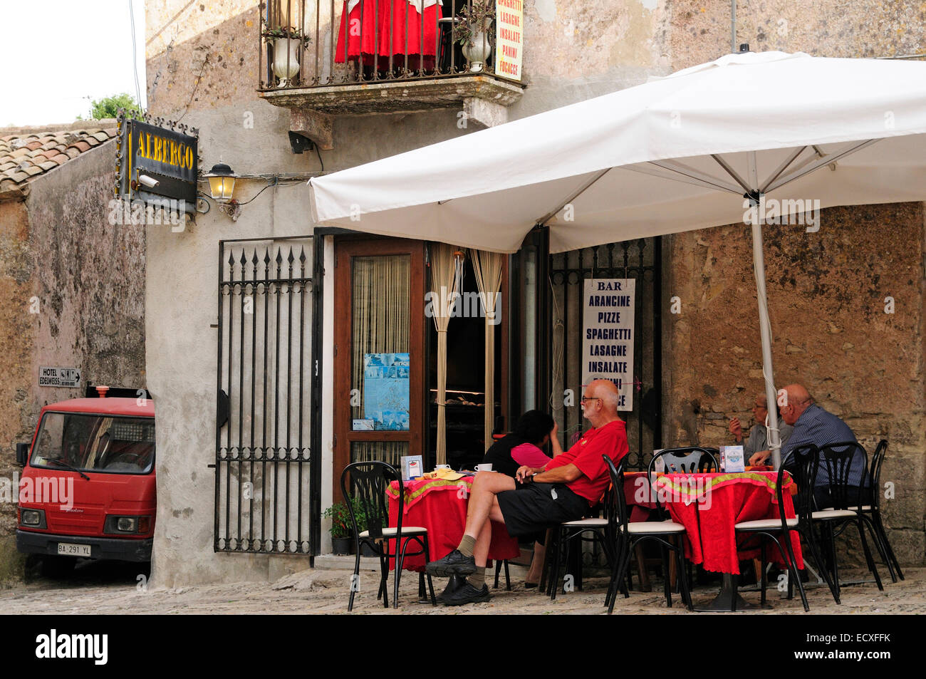 Cafe tables people eating lunch main square Erice Sicily Italy Stock Photo