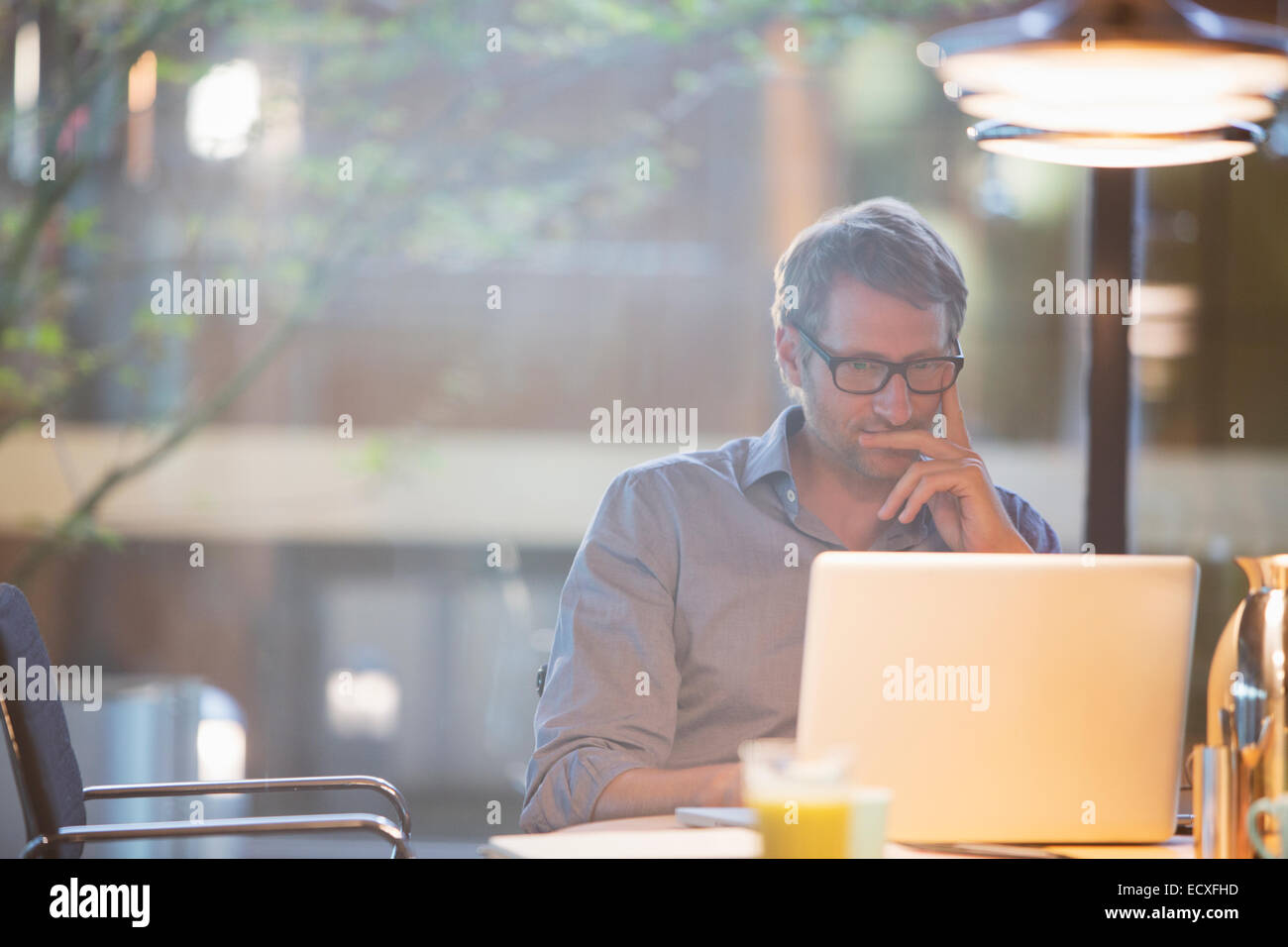 Businessman working on laptop in office Stock Photo