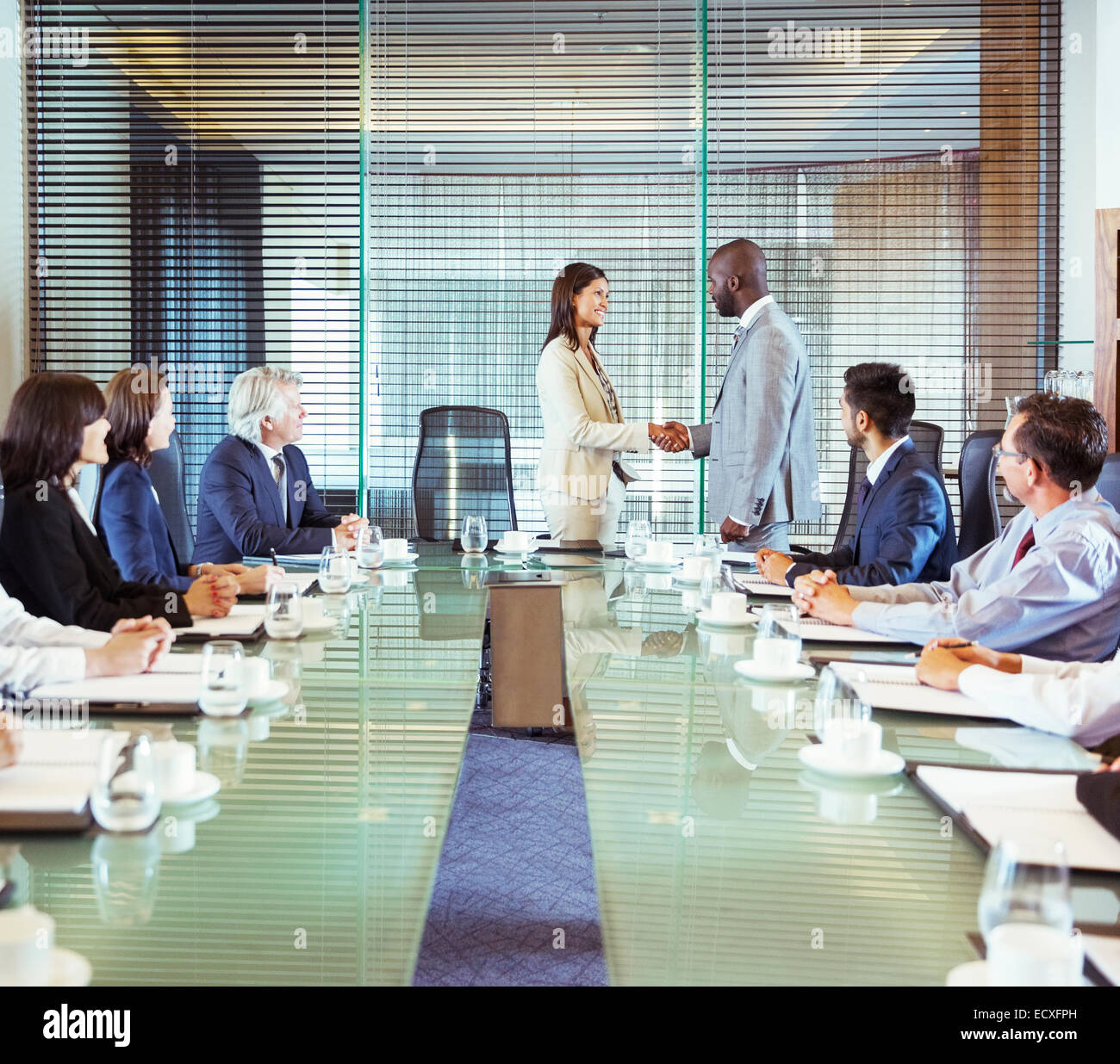 Business people shaking hands in conference room during business meeting Stock Photo