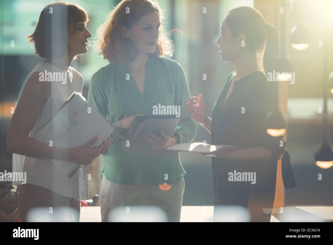 Businesswomen talking in office Stock Photo - Alamy
