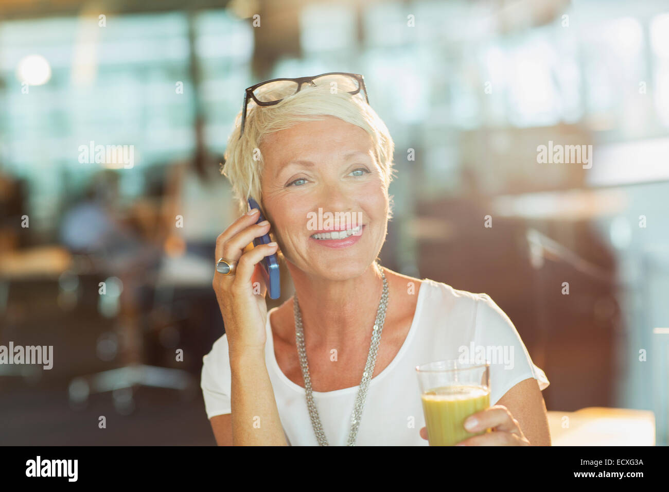 Businesswoman talking on cell phone in office Stock Photo