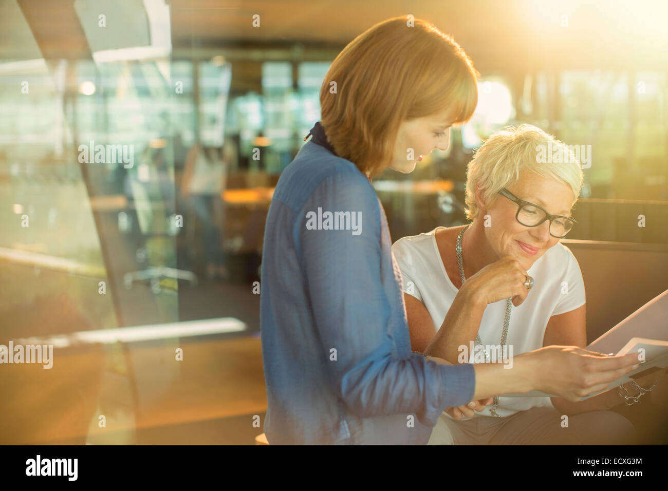 Businesswomen working together in office Stock Photo - Alamy