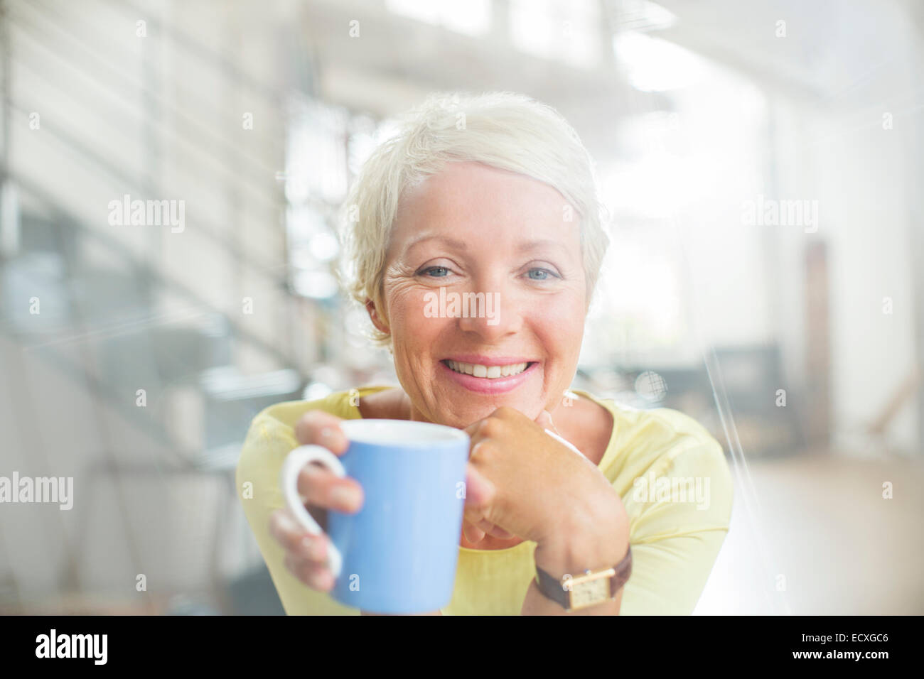 Older woman drinking cup of coffee Stock Photo Alamy