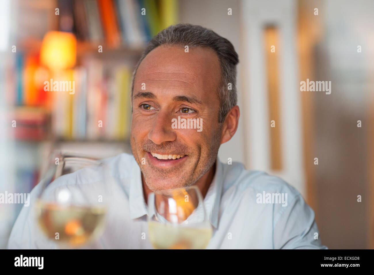 Older man drinking white wine Stock Photo