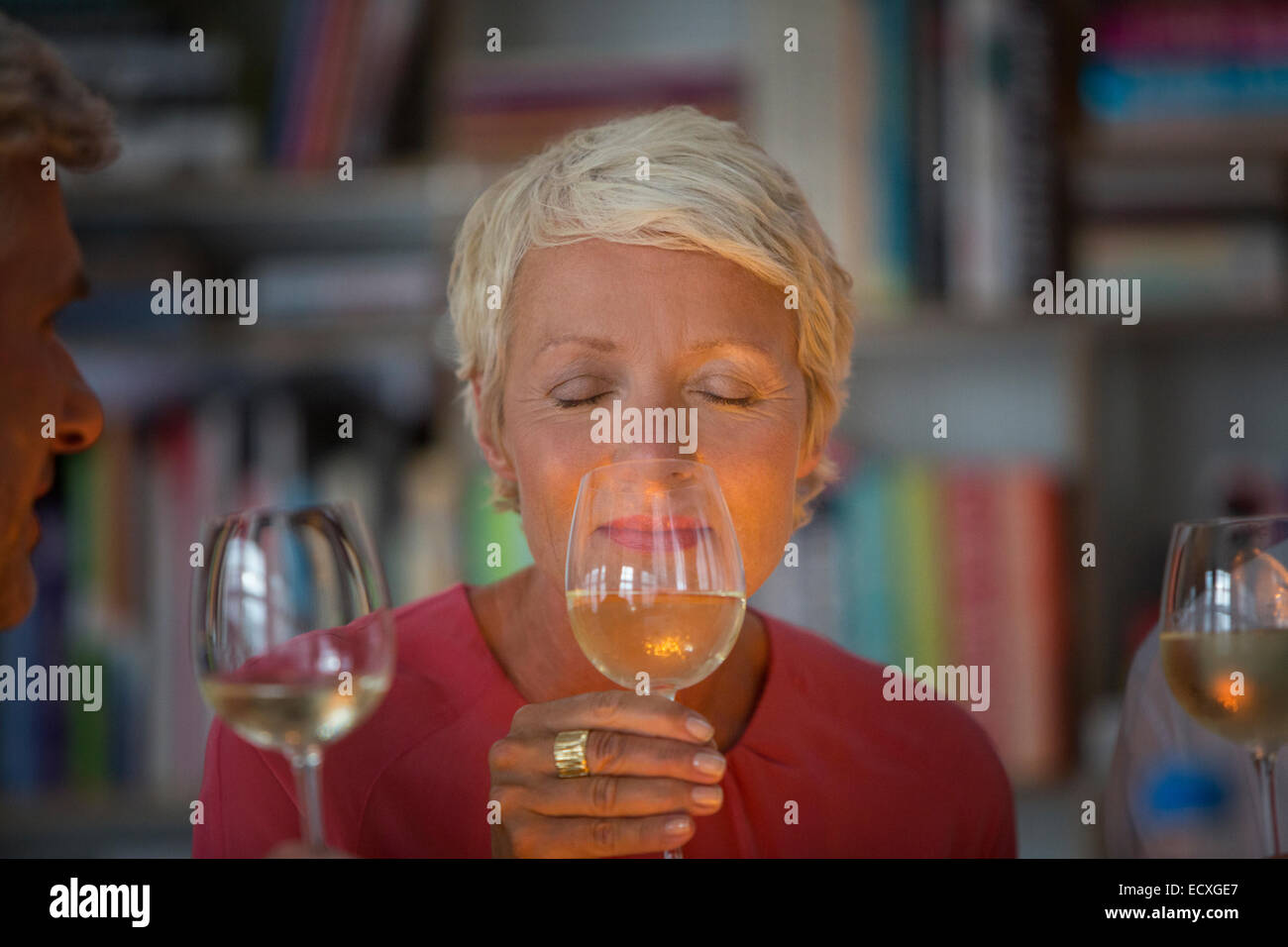 Older woman smelling white wine Stock Photo