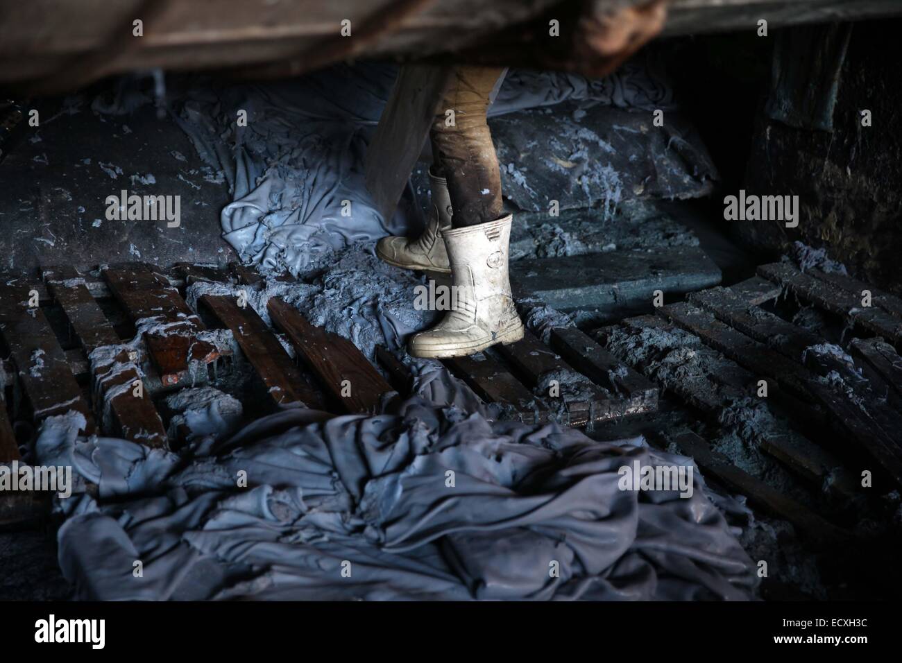 Cairo, Egypt. 20th Dec, 2014. An Egyptian worker carries leather at a leather tanning factory in