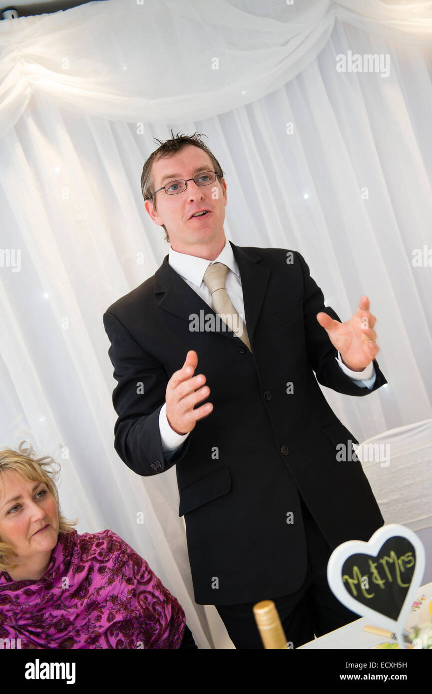 Getting married / Wedding day UK: the Best Man giving his speech at a wedding reception celebration party after the wedding service Stock Photo