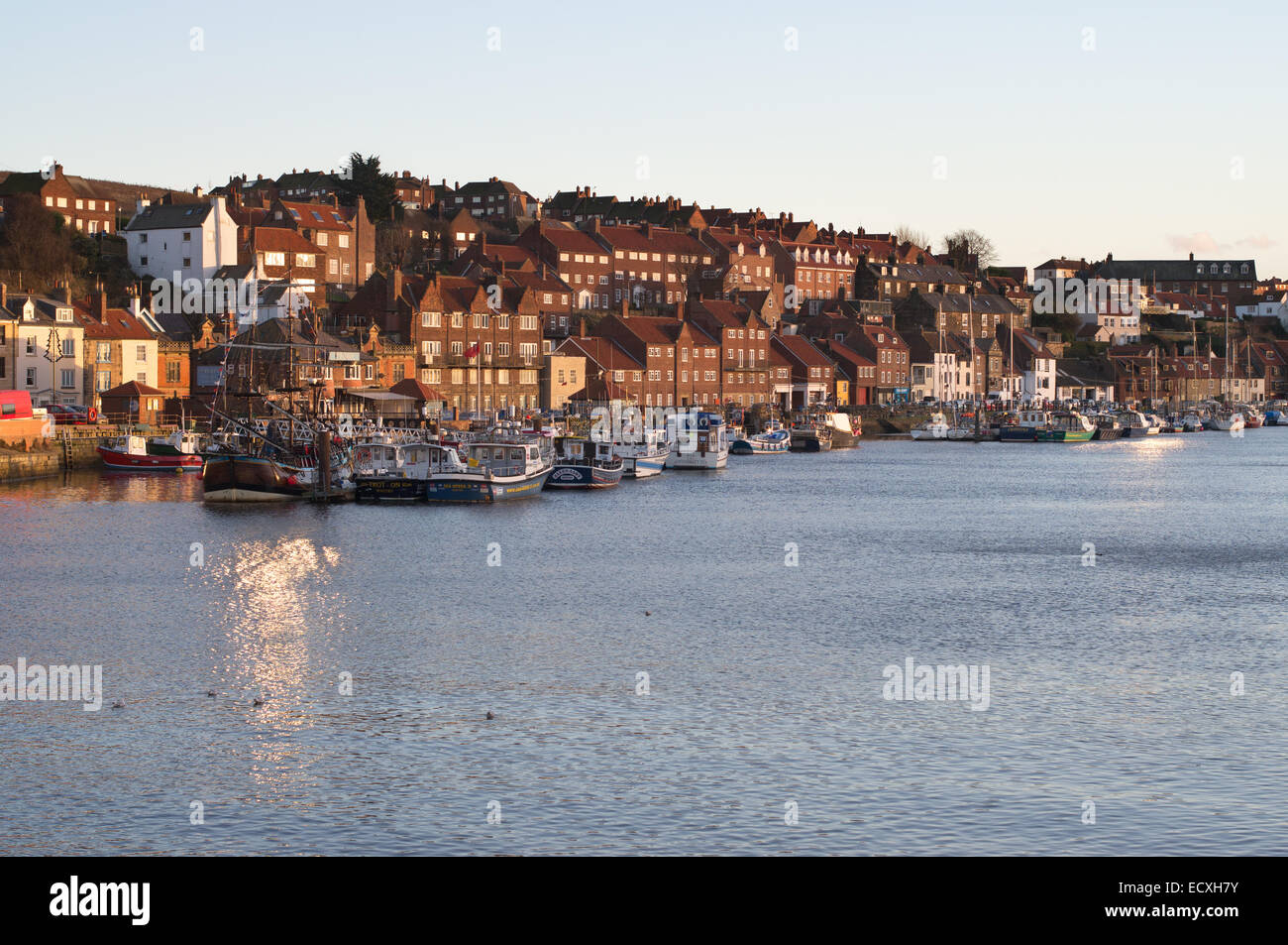 Whitby harbour seen in late afternoon winter sunshine, North Yorkshire, England, UK Stock Photo