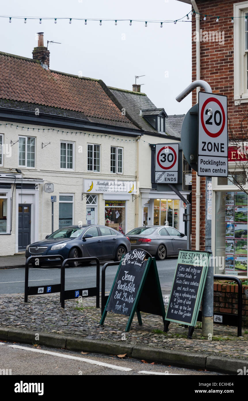 30 and 20 mph zone speed limit signs on a road junction in England. Stock Photo
