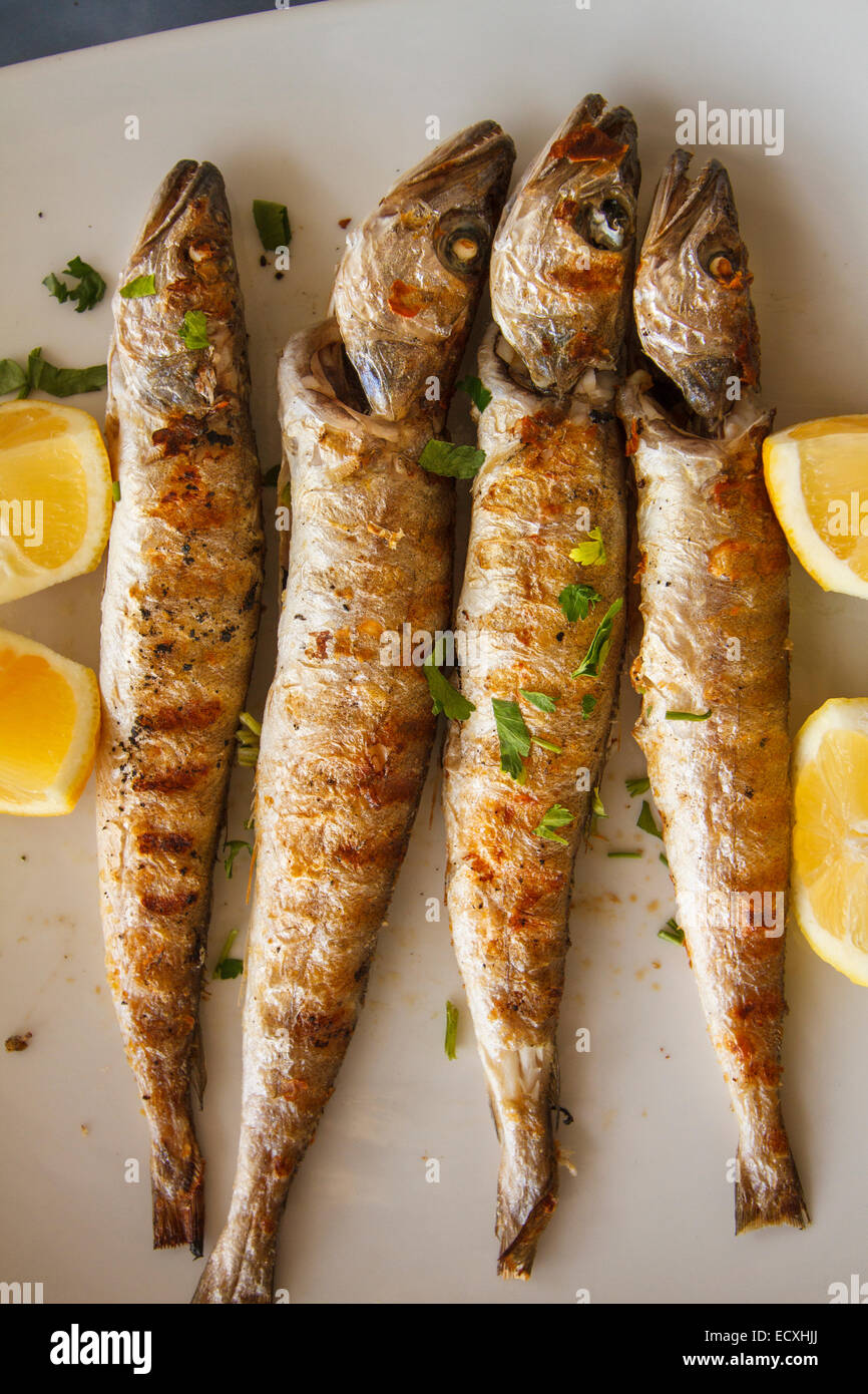 A traditional Greek food dish with small Hakes and lemons. Peloponnese, Greece Stock Photo
