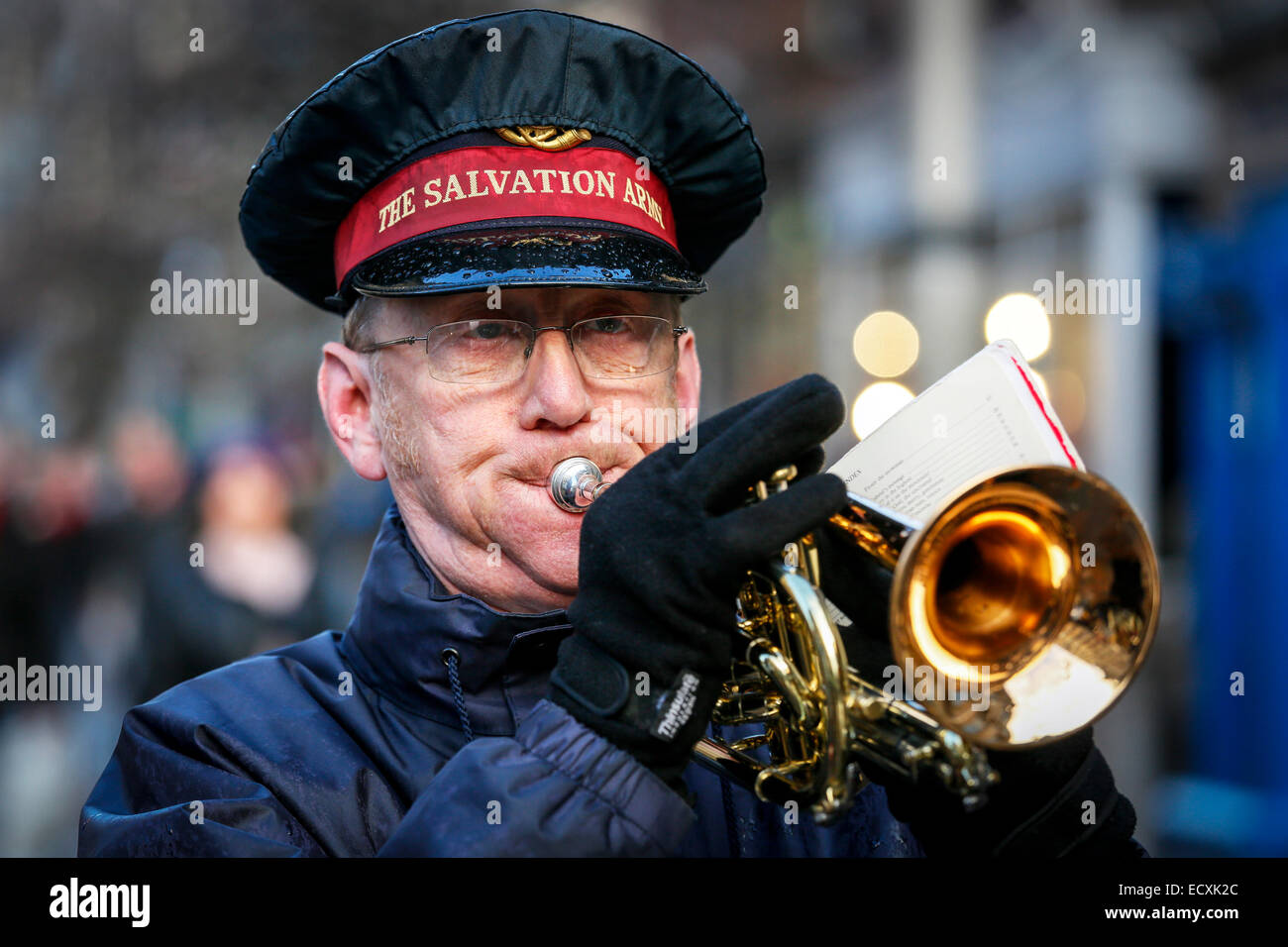 member of the Salvation Army playing the trumpet at a Christmas service, Glasgow, Scotland, Uk Stock Photo