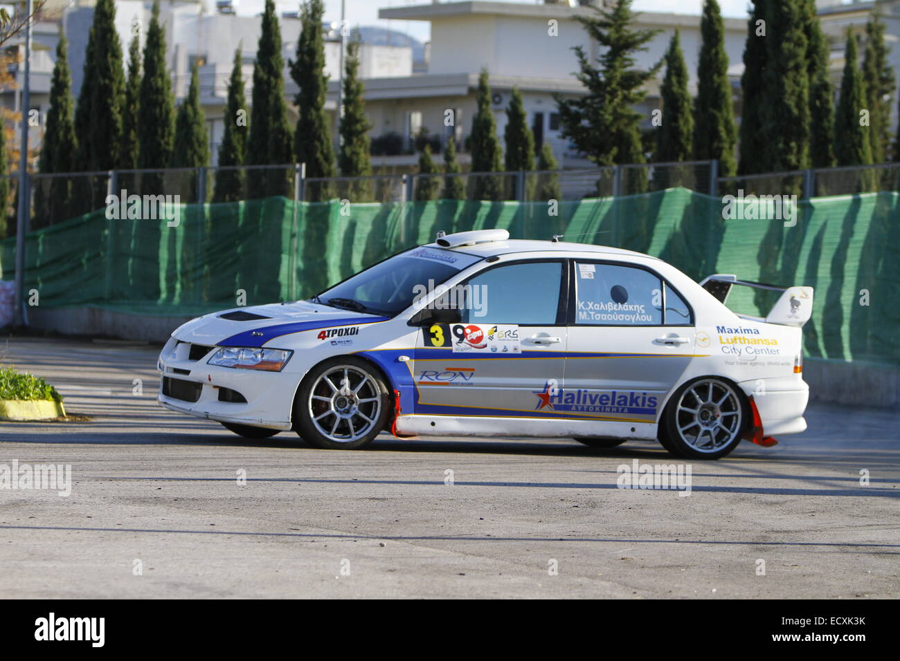 Athens, Greece. 21th Dec 2014. Greek rally driver Konstantinos Chalivelakis and his co-driver Marios Tsaousoglou race in a Mitsubishi Evo 8 in the Golden Rally Show 2014. The first Golden Rally Show was held in the Athens Olympic Sports Complex. The race is a continuation of the 'Nino Memorial race' that was held annually in remembrance of Greek driver Nino Samaropoulou. Credit:  Michael Debets/Alamy Live News Stock Photo