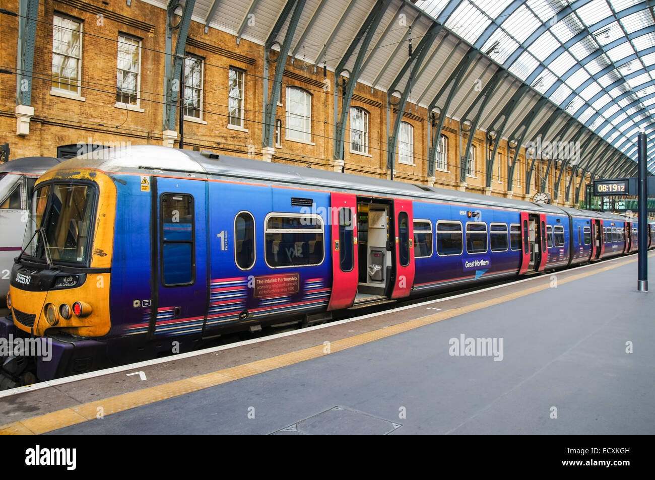 Great Northern train on the platform at Kings Cross railway train station, London England United Kingdom UK Stock Photo