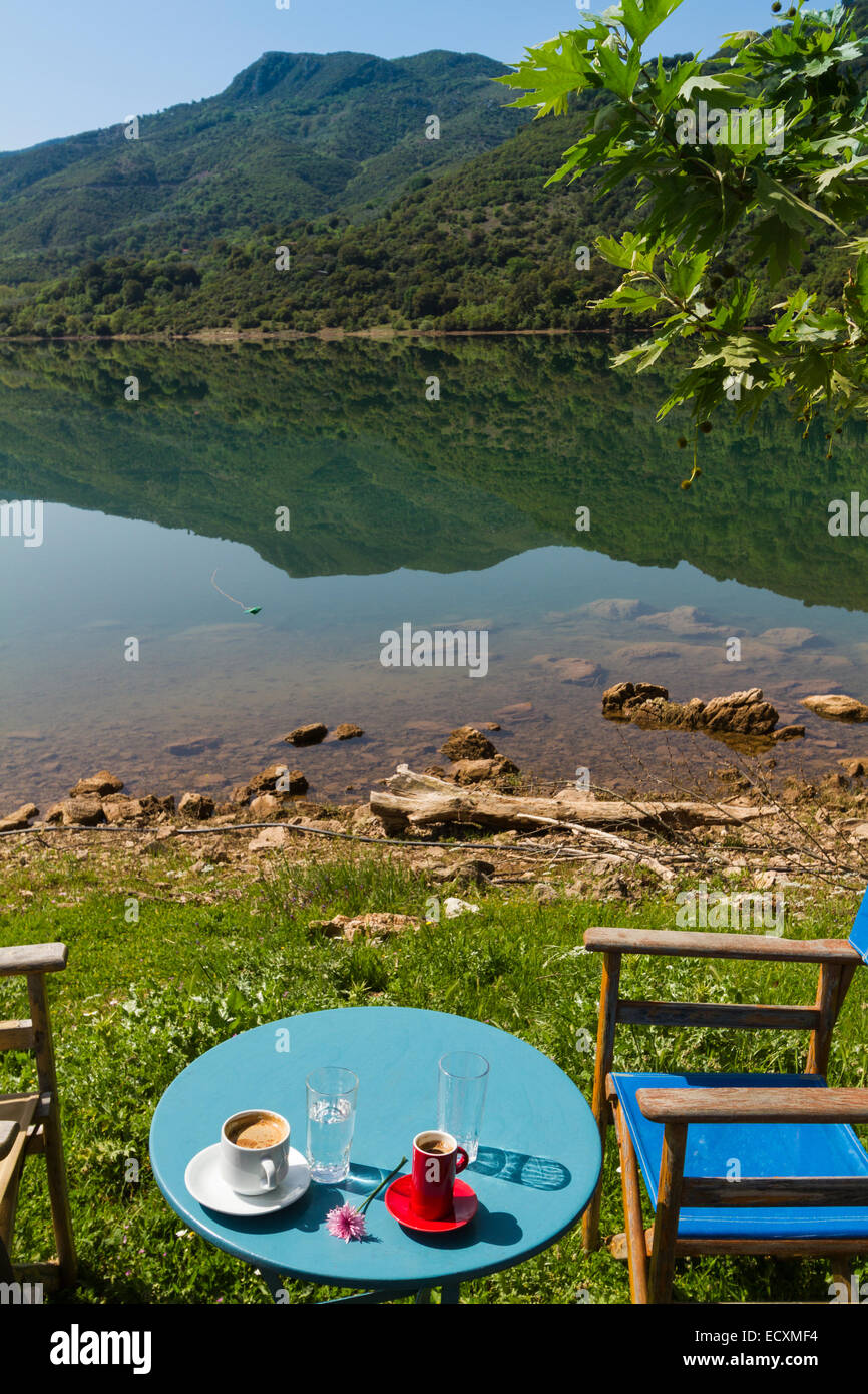 The table and chairs of a Cafe next to Ladon lake. Arcadia, Peloponnese, Greece Stock Photo
