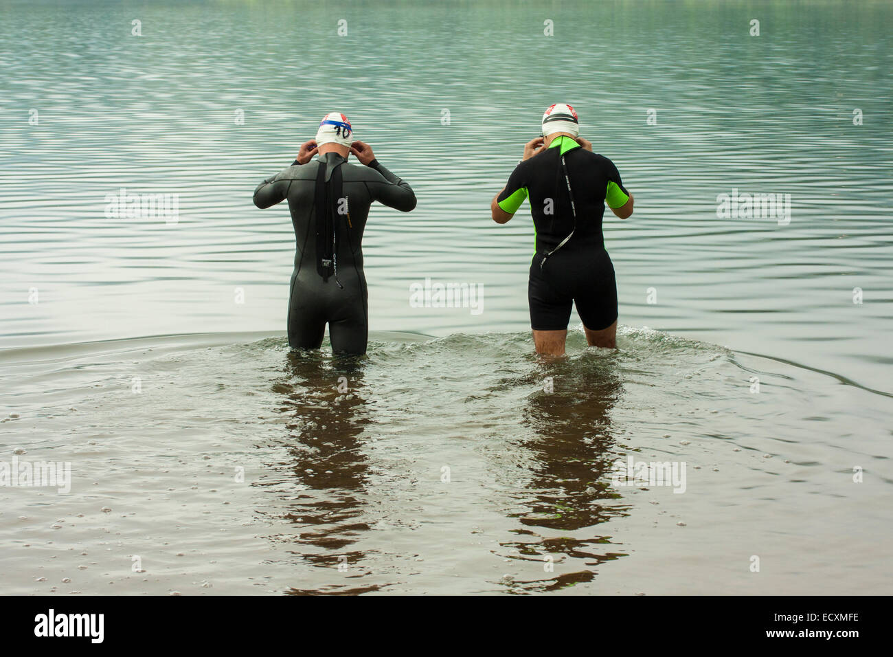 Athletes testing the waters before the start of a triathlon event at Ladon lake. Arcadia, Peloponnese, Greece Stock Photo