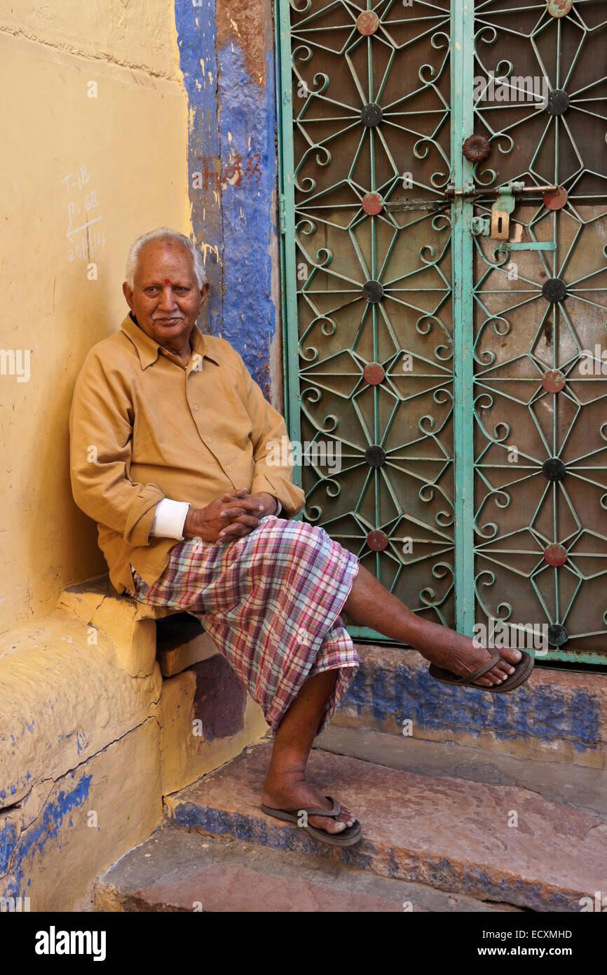 Old man sitting outside his home in the Blue City, Jodhpur, Rajasthan, India Stock Photo